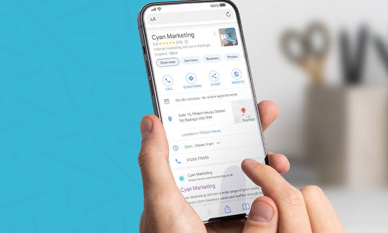 hands holding phone showing Cyan Marketing google profile