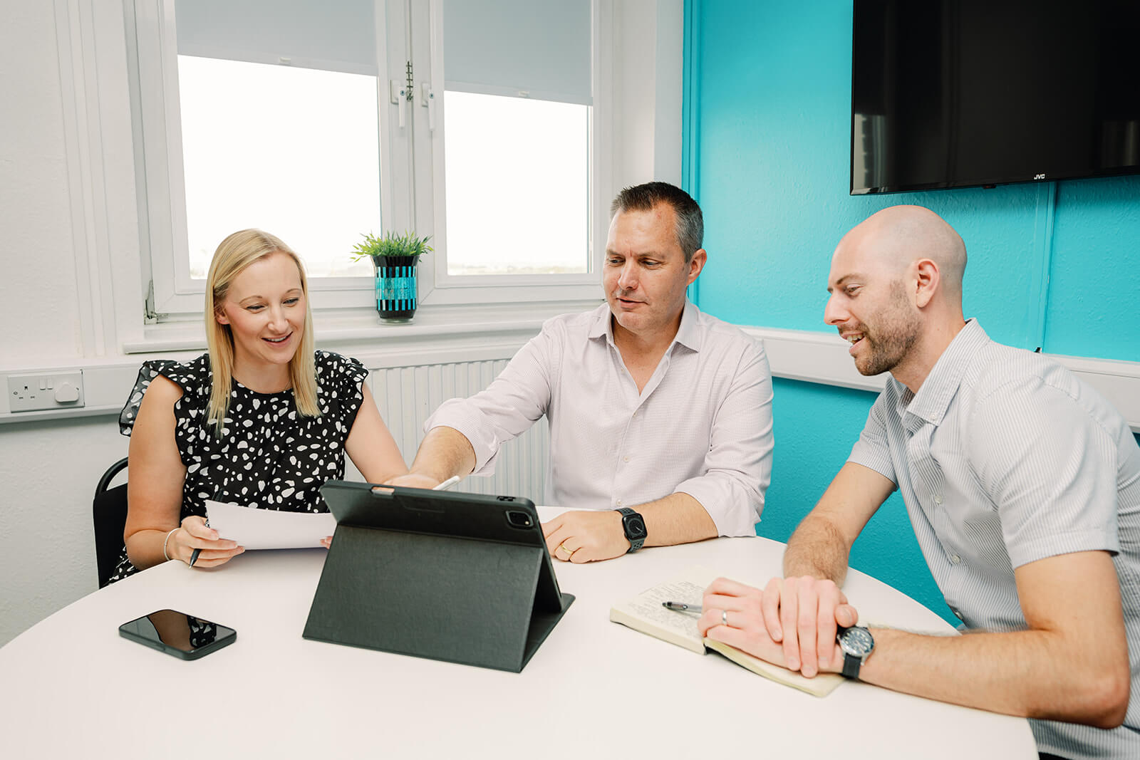 marketing team discussion with ipad on desk